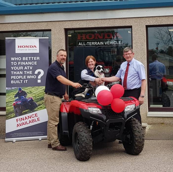 Zoey Rennie and Mac-the-sheepdog collected the quad bike from John Fyall, NSA Scottish Region committee member (left), and Ben Ewan of AM Phillip Agritech.